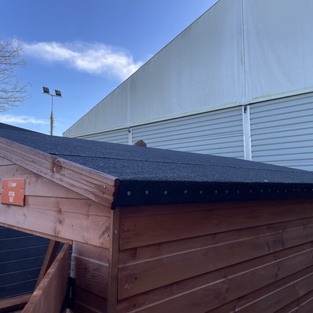 Wooden potting shed roof with asphalt covering