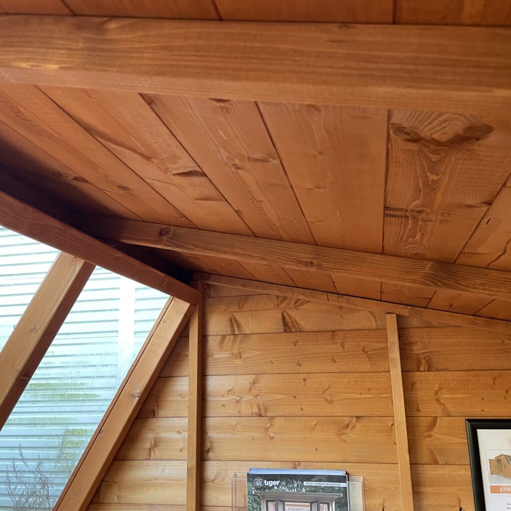 Interior view of a Tiger Potting Shed highlighting wooden beams and wall panels
