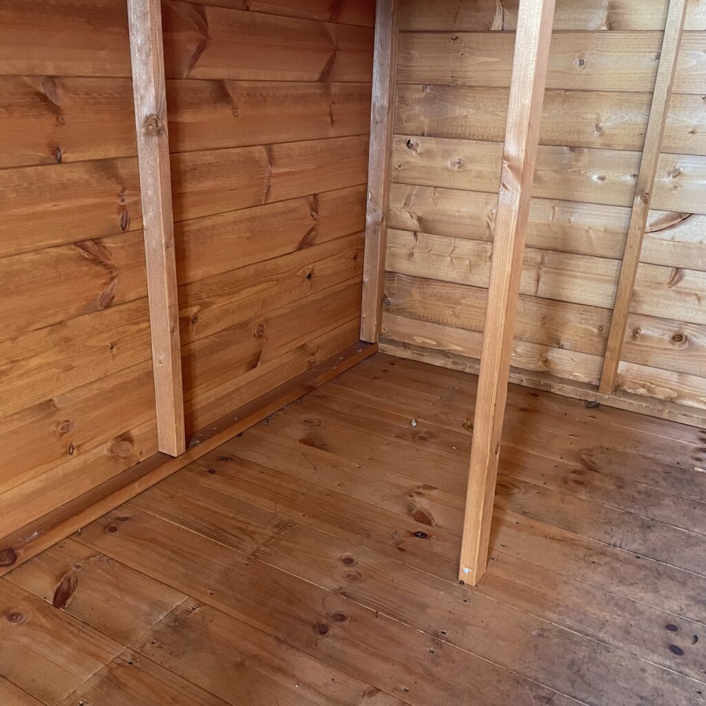 Interior of a Tiger Potting Shed featuring wooden walls and floor