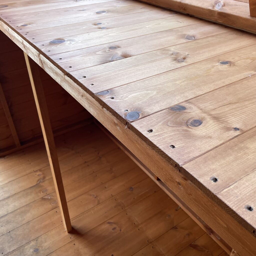 Interior view of a wooden workbench in a potting shed