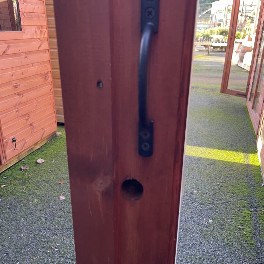 Close-up of the door handle and frame of the Tiger Retreat Contemporary Summerhouse