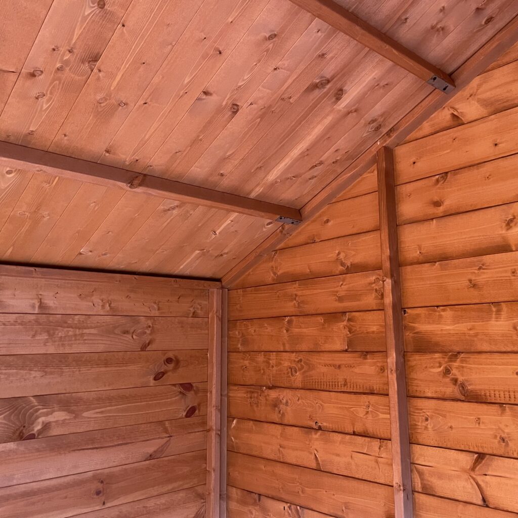 Interior view of the Tiger Retreat Contemporary Summerhouse showcasing wooden walls and ceiling