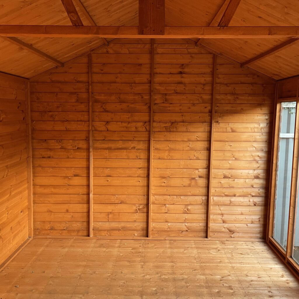Interior of the Tiger Retreat Contemporary Summerhouse with wooden walls and flooring