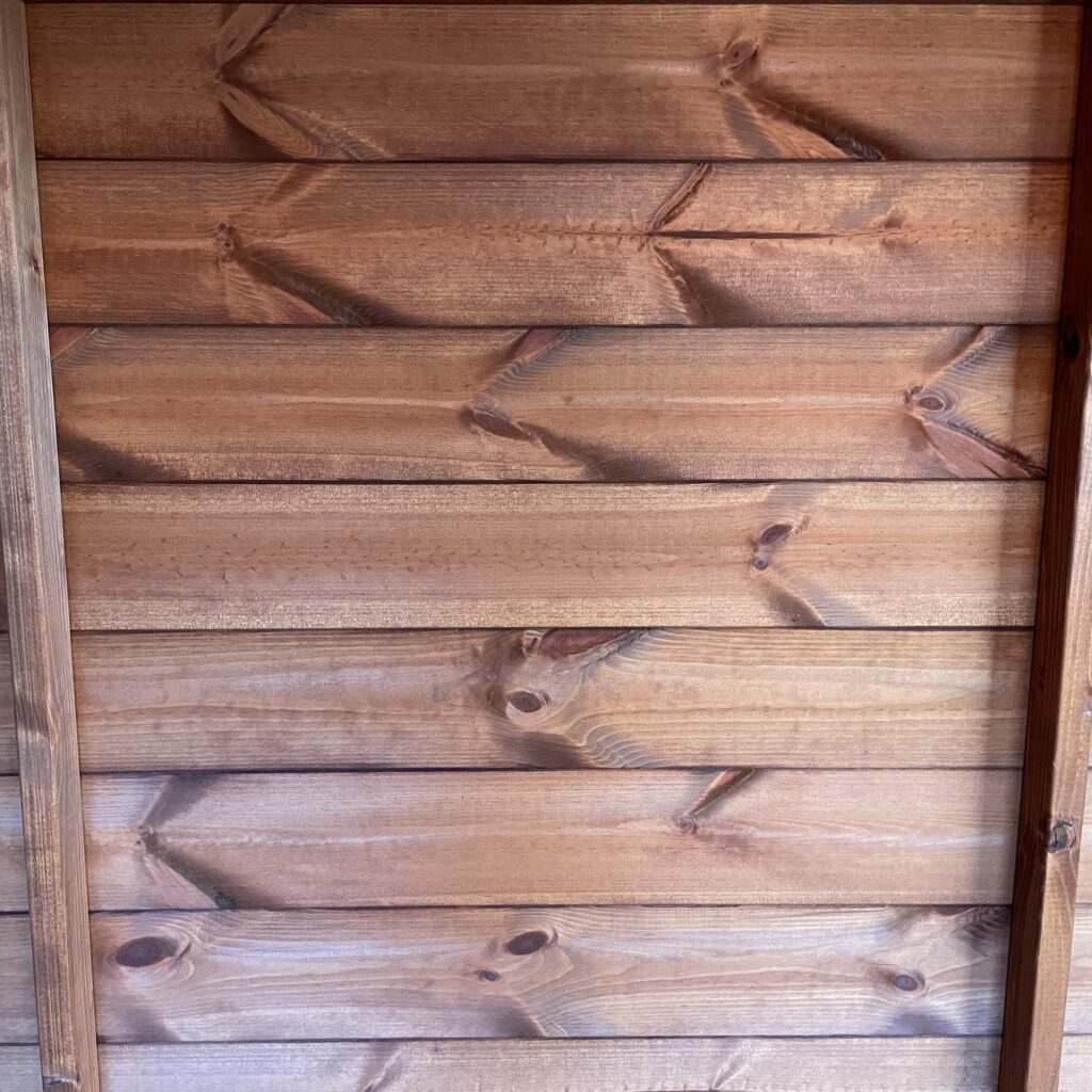 Close-up of Tiger Shiplap Apex Shed's shiplap cladding showing natural wood grain