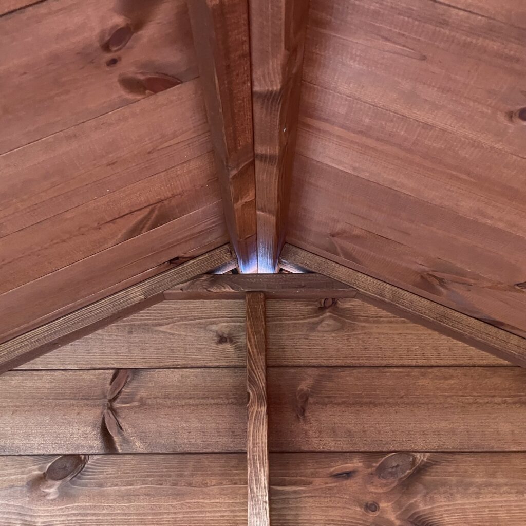 Interior view of apex roof structure showing wooden beams and joinery
