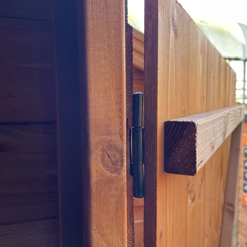 Close-up of the hinge and cladding of a Tiger Shiplap Pent Shed