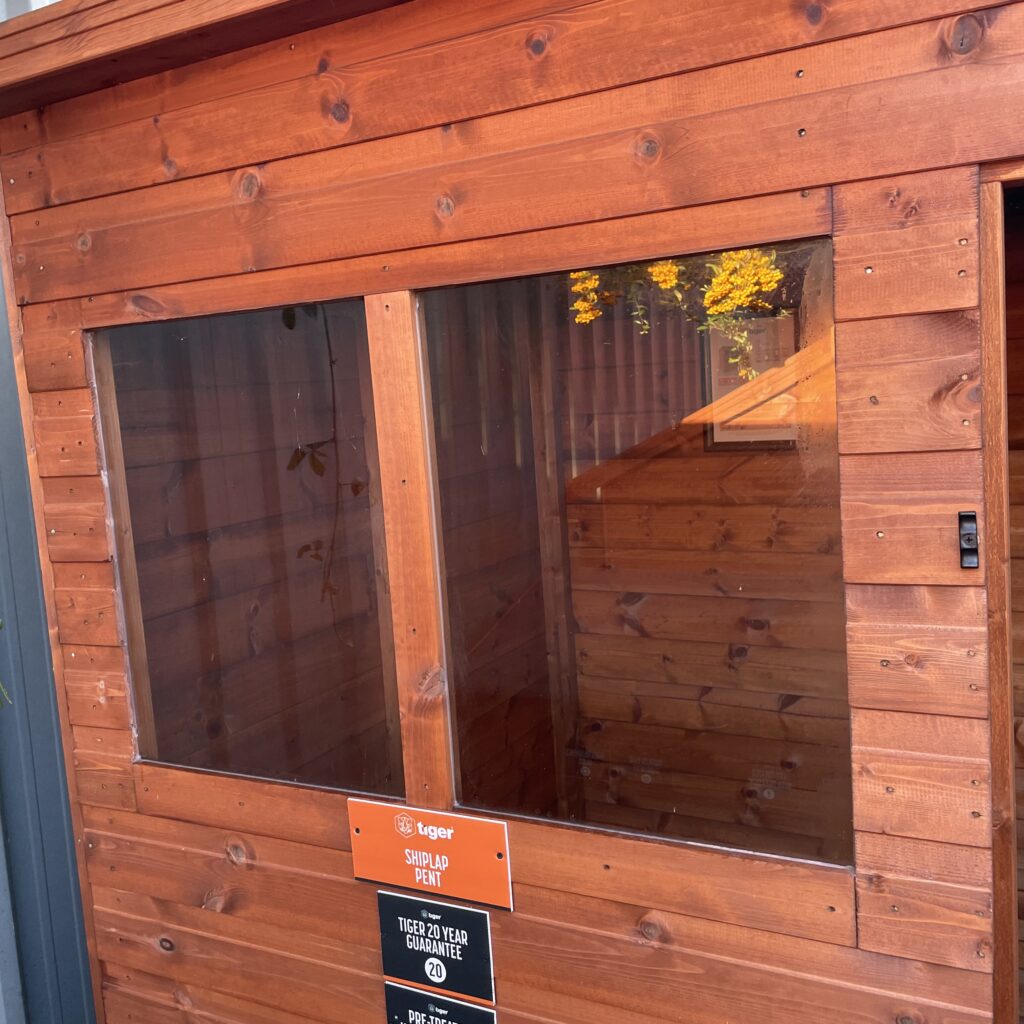 Front view of a Tiger Shiplap Pent Shed showcasing large windows