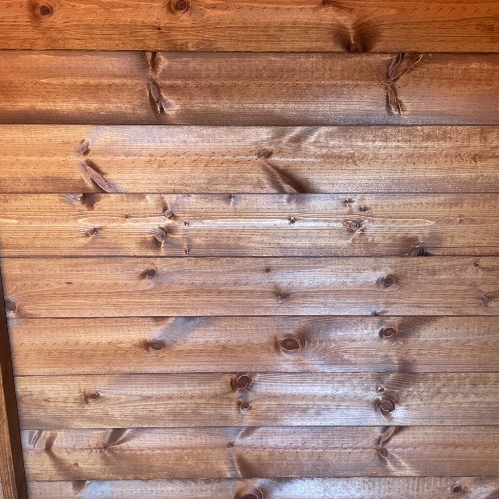 Interior wall cladding of a Tiger Shiplap Pent Shed showcasing smooth timber finish