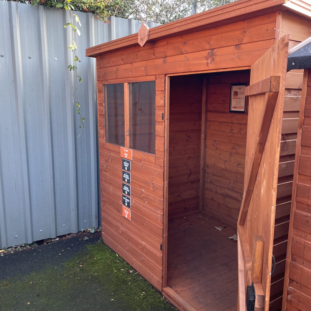 Tiger Shiplap Pent Shed showcasing open door and wooden interior
