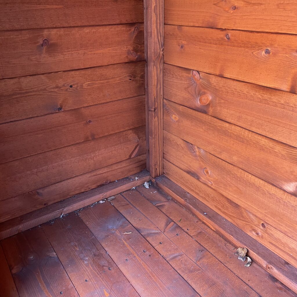 Interior view of a wooden storage box showcasing smooth walls and flooring