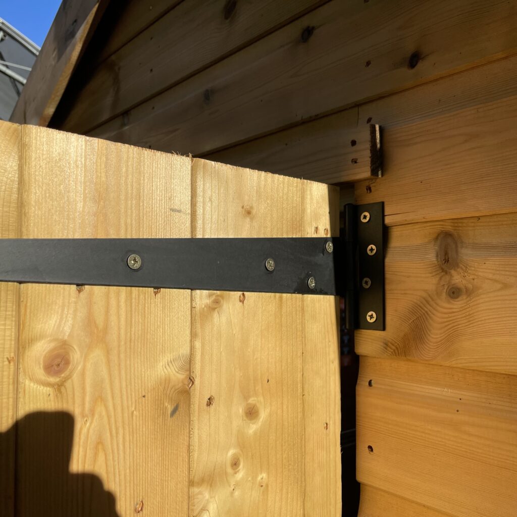 Timber door with black strap hinge detail