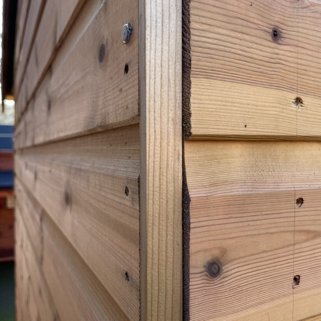 Detailed view of timber cladding on a garden building