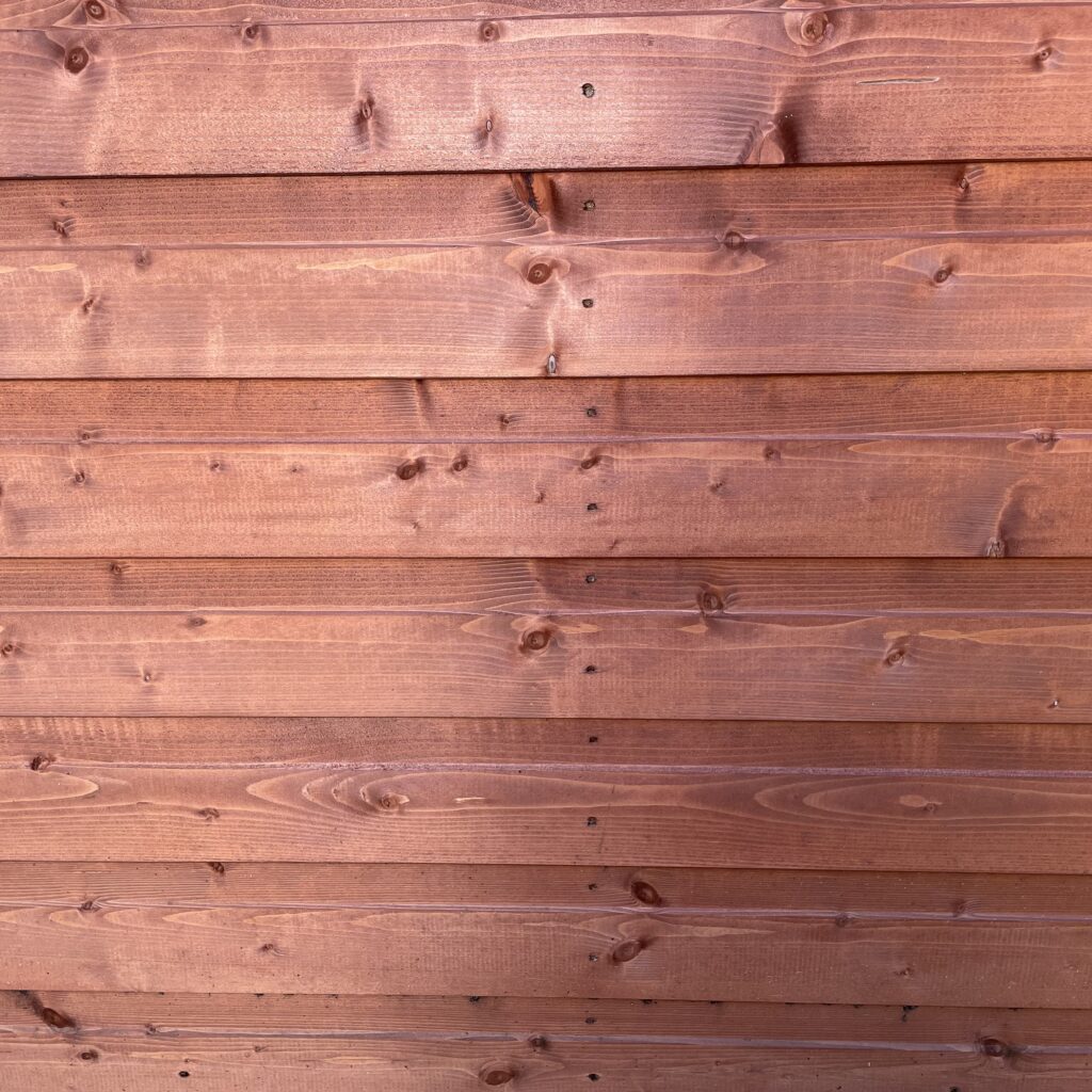Timber cladding with a smooth finish and visible knots