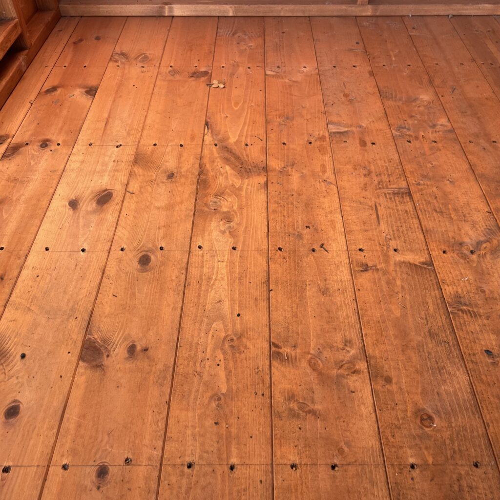 Close-up of a wooden floor in a garden building