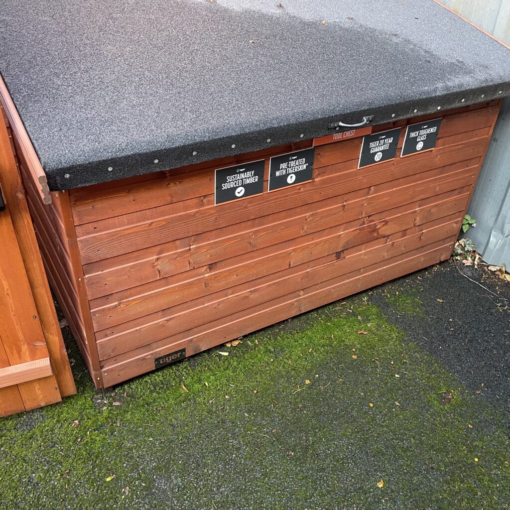 Wooden tool chest with a flat roof and signage