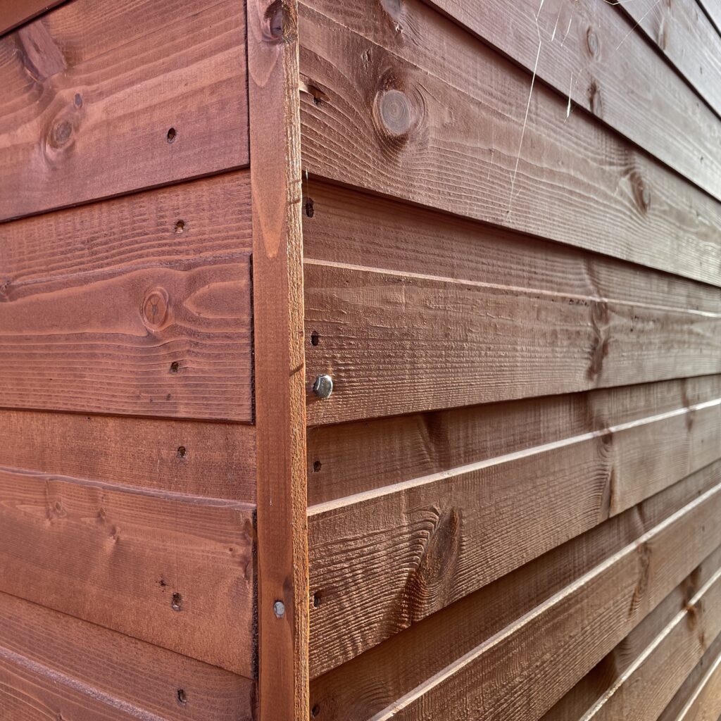 Wooden cladding showcasing the robust construction of a Tiger Workman Apex Shed