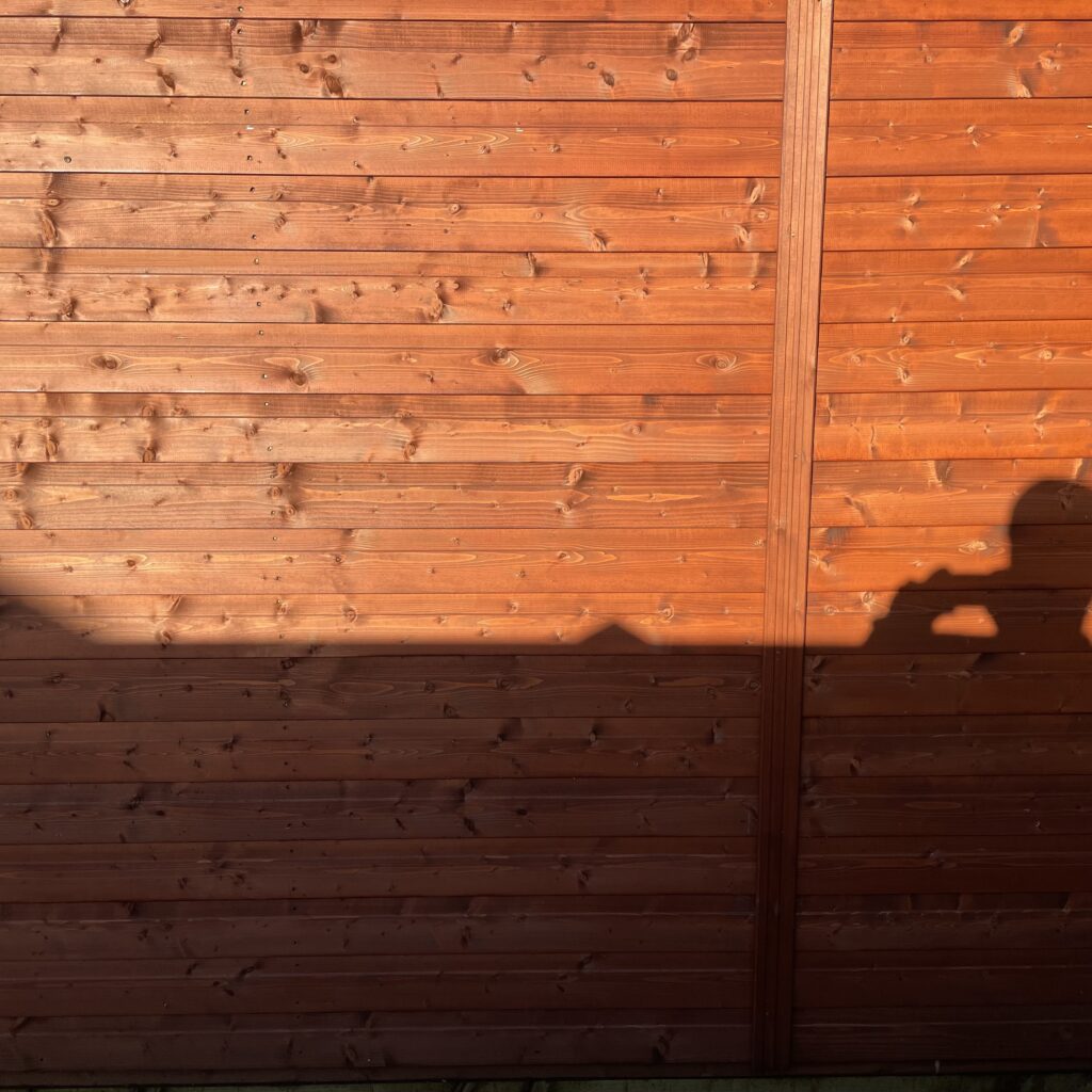 Wooden cladding of a Tiger Workman Apex Shed in rich brown finish