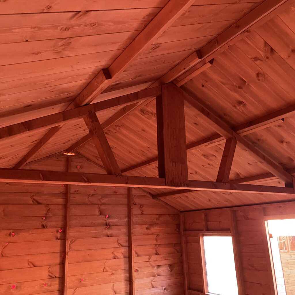 Interior view of a Tiger Workman Apex Shed showcasing wooden beams and apex roof structure