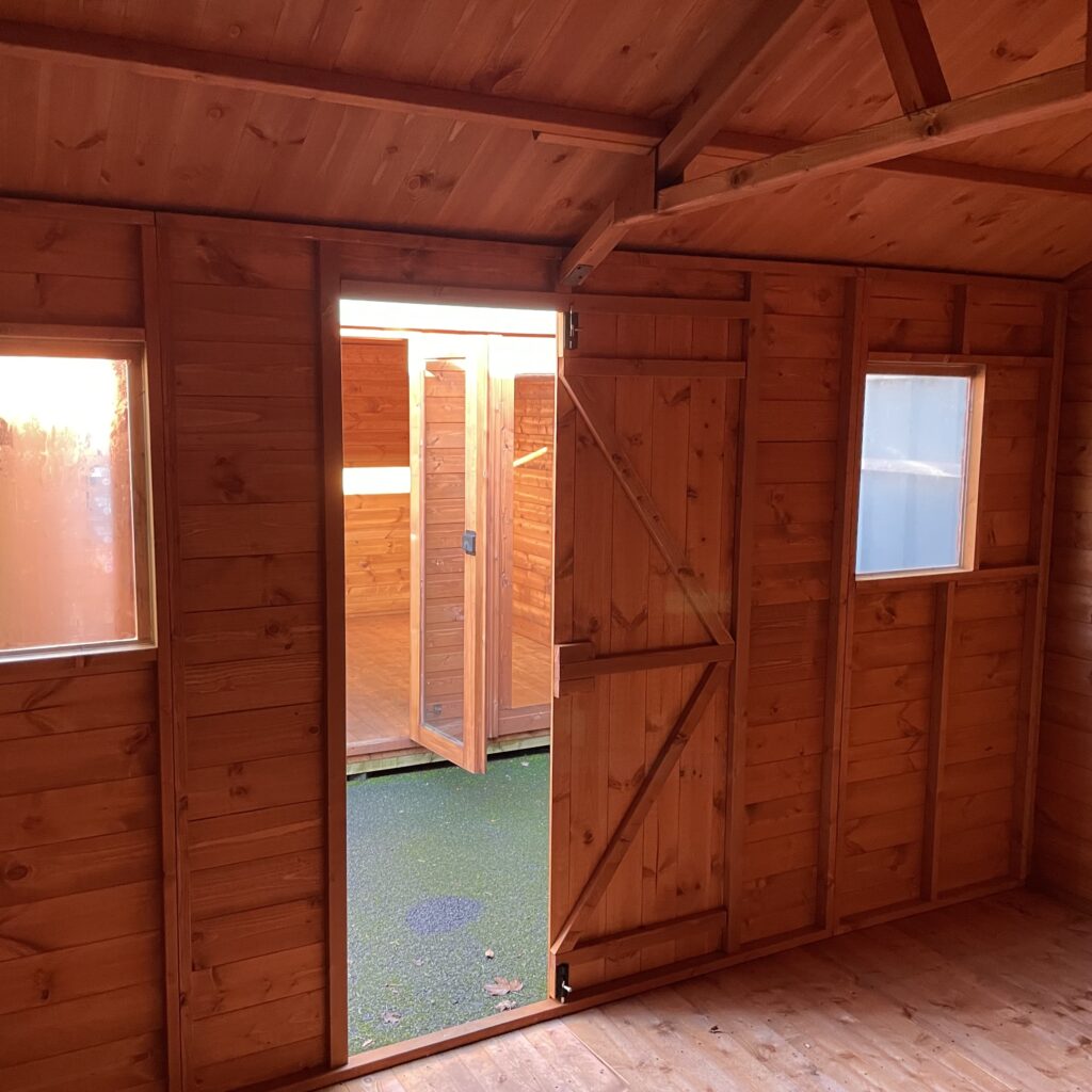 Interior view of a Tiger Workman Apex Shed with double doors and windows