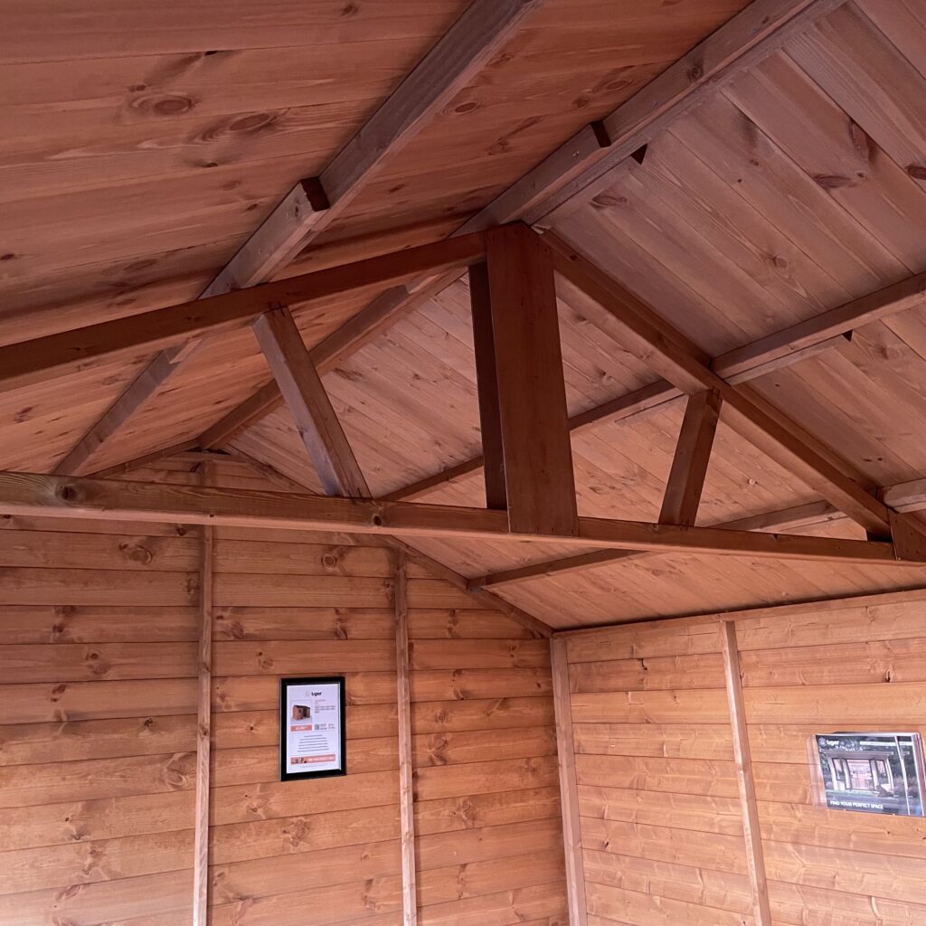 Interior view of the Tiger Workman Apex Shed with visible apex roof and wooden walls