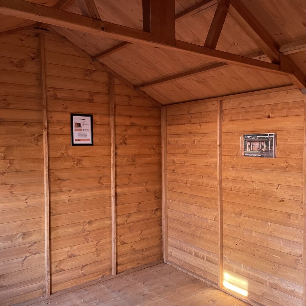 Interior view of the Tiger Workman Apex Shed with wooden walls and beams