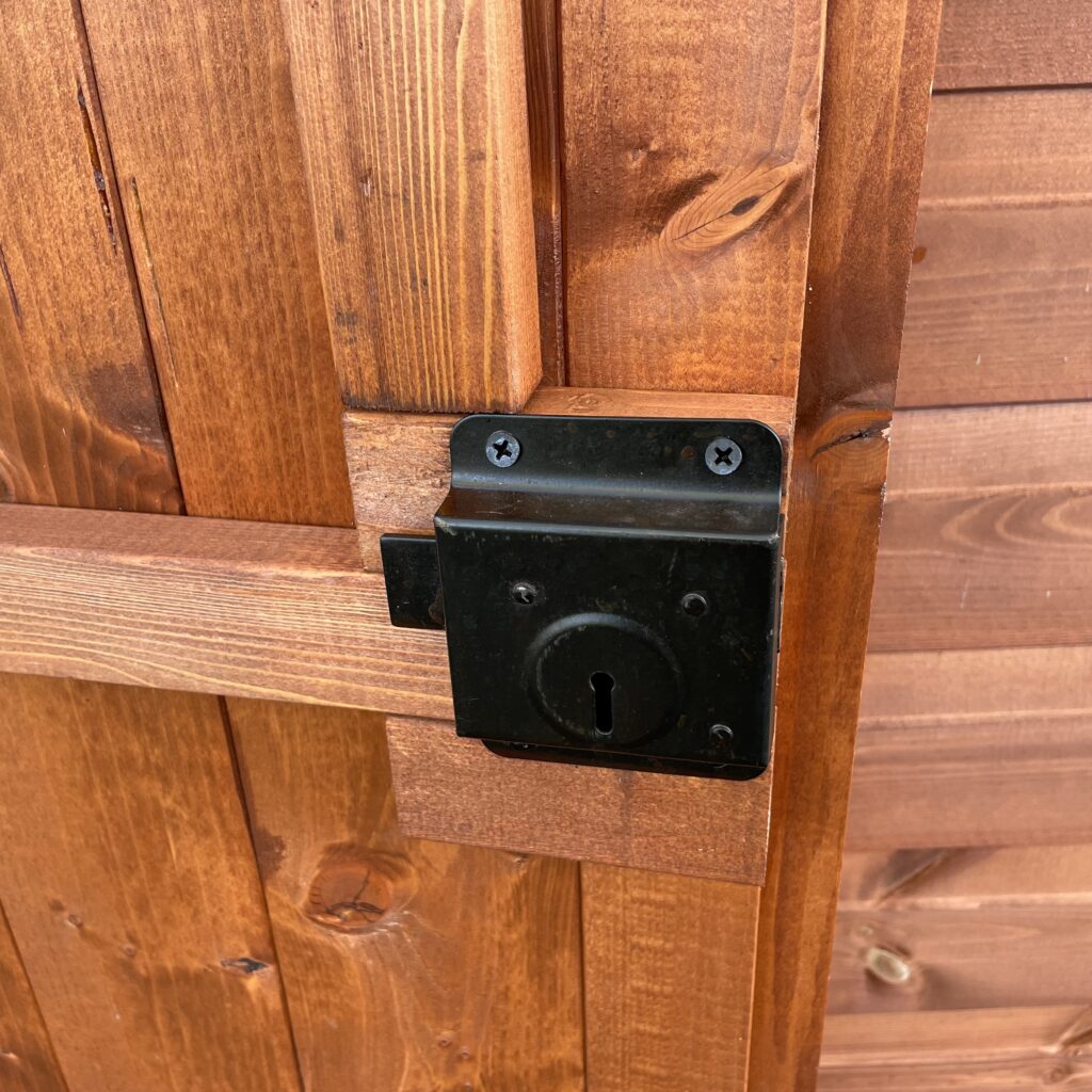 Lock mechanism on a wooden door of a garden workshop