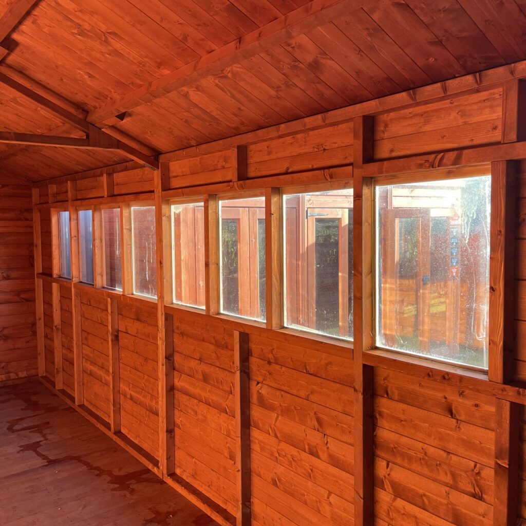 Interior view of the Tiger XL Heavyweight Workshop with wooden walls and multiple windows