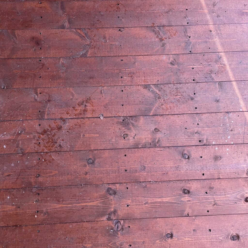 Close-up of wooden floorboards in a bike shed