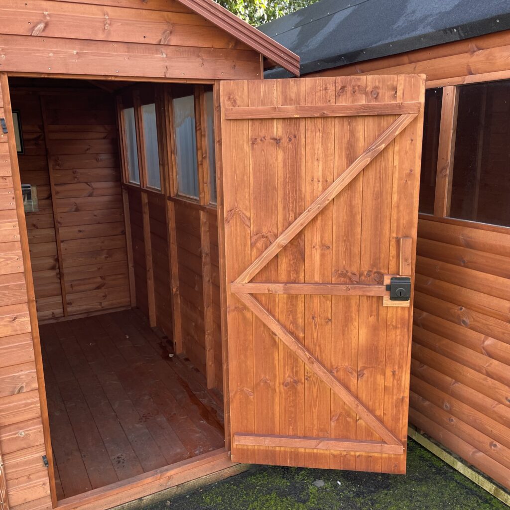 Open door of a TigerFlex Shiplap Apex Shed revealing interior space