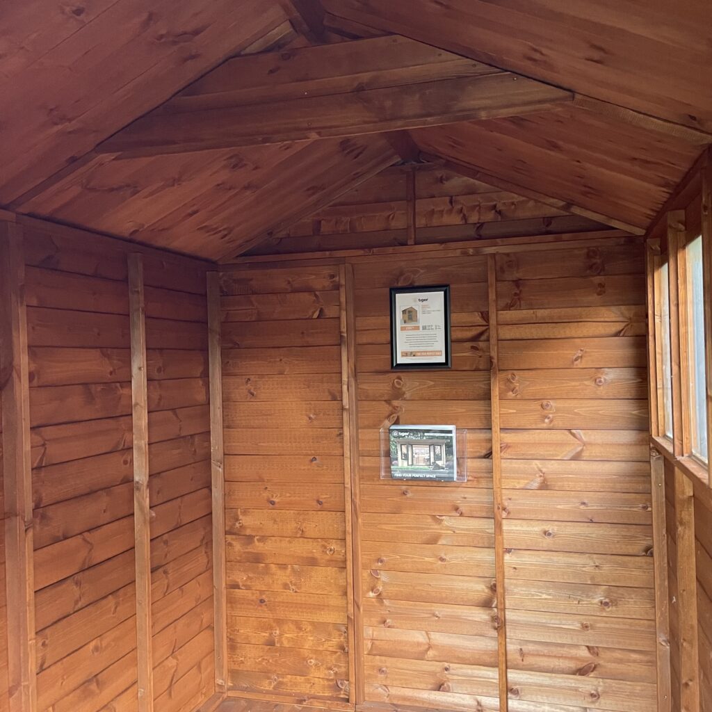 Interior view of a TigerFlex Shiplap Apex Shed with wooden walls and apex roof