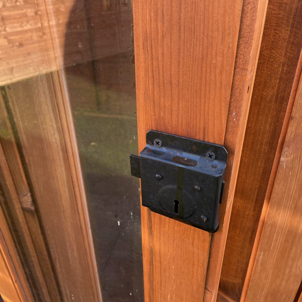 Close-up of the door lock mechanism on a summerhouse