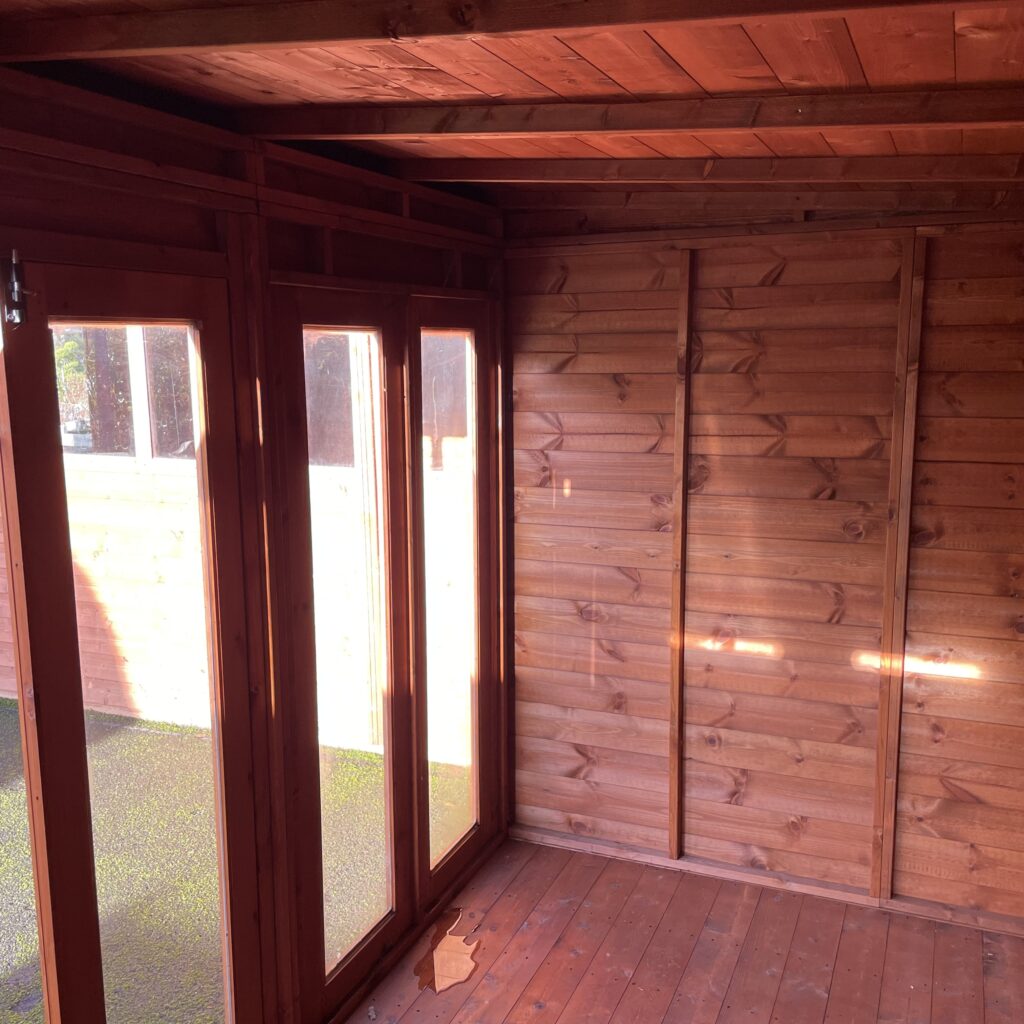 Interior view of the TigerFlex Shiplap Pent Full Pane Summerhouse showcasing full-pane windows