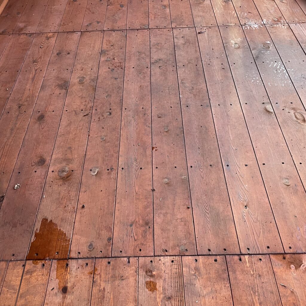 Interior view of wooden floor in a summerhouse showing grain and finish