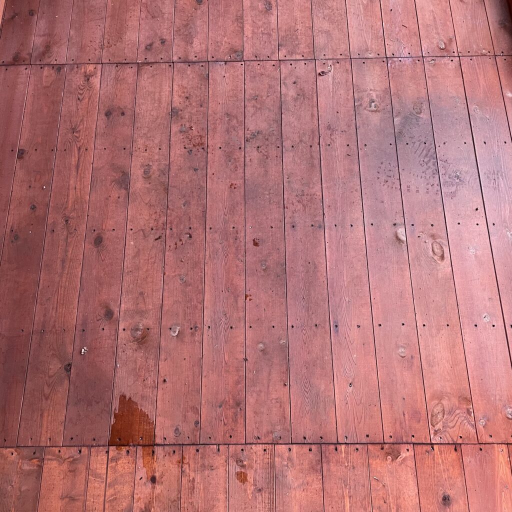 Wooden flooring of the TigerFlex Shiplap Pent Full Pane Summerhouse showing grain and water marks