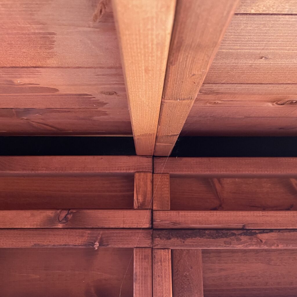 Internal view of the roof structure with visible beams and joinery