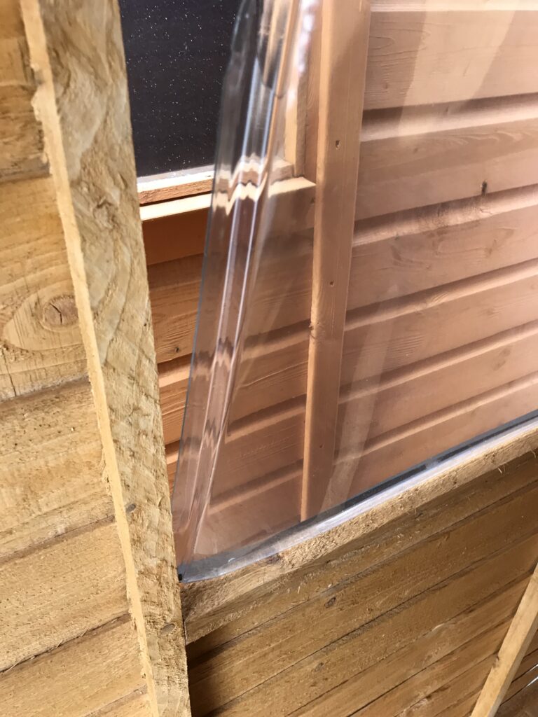 Cheaper alternative showing the poor quality glazing. This image shows some of the poorest quality glazing we have found on a shed. It was super thin polycarbonate that was vacuum formed to give it strength. We were still able to push it out of its mounting with very little effort.